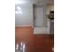 Open-concept living area with hardwood floors that flow into the kitchen with white tile at 4111 Pine Heights Ne Dr, Atlanta, GA 30324