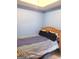 Simple bedroom with light blue walls, a wooden bed frame, and minimal decor at 11714 Double Lake Xing, Fayetteville, GA 30215