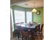 Charming dining area with a large table, eight chairs, and natural light from bright windows at 11714 Double Lake Xing, Fayetteville, GA 30215