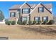 Charming two-story brick home featuring well-manicured landscaping and classic architectural details at 11714 Double Lake Xing, Fayetteville, GA 30215