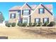 Beautiful brick two-story home with well-manicured bushes, a bay window, and a front door wreath at 11714 Double Lake Xing, Fayetteville, GA 30215