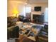 Cozy living room with a fireplace, plush seating, a ceiling fan, and a colorful area rug at 11714 Double Lake Xing, Fayetteville, GA 30215