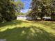Backyard featuring mature trees and a large lawn at 47 Elm St, Hampton, GA 30228