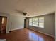 Bright bedroom with hardwood floors, a ceiling fan, and a view of the outdoors at 47 Elm St, Hampton, GA 30228