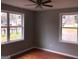 Bedroom with hardwood floors, neutral wall color, and a ceiling fan, providing a comfortable living space at 47 Elm St, Hampton, GA 30228