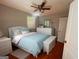 Well-lit bedroom with a ceiling fan, hardwood floors, and large window at 47 Elm St, Hampton, GA 30228