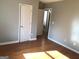 Cozy bedroom with hardwood floors and neutral gray paint at 47 Elm St, Hampton, GA 30228
