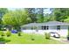 Single-story home features a well-maintained lawn and front yard, enhancing its curb appeal at 47 Elm St, Hampton, GA 30228