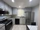 Modern kitchen featuring stainless steel appliances, granite countertops, and ample cabinet space at 47 Elm St, Hampton, GA 30228