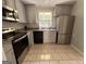 Updated kitchen with stainless steel appliances, granite counters, and stylish cabinetry at 47 Elm St, Hampton, GA 30228