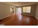 Bright living room featuring hardwood floors and ample natural light from large windows at 47 Elm St, Hampton, GA 30228