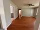 Open living area with hardwood flooring, neutral walls, and ceiling fan at 47 Elm St, Hampton, GA 30228