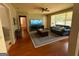 Comfortable living room with hardwood floors, large windows, and a ceiling fan at 47 Elm St, Hampton, GA 30228