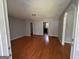 Inviting living room with gleaming hardwood floors, neutral paint, and an open layout at 47 Elm St, Hampton, GA 30228