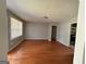Spacious living room with hardwood floors, freshly painted walls, and a light-filled atmosphere at 47 Elm St, Hampton, GA 30228