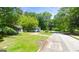 Street view of property with adjacent home, mature trees, and visible street name at 47 Elm St, Hampton, GA 30228