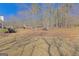 Large backyard featuring mature trees, a wooden deck and natural surroundings at 245 Longshore Way, Fayetteville, GA 30215