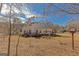 Expansive backyard with a wooden deck, swing set, and lush greenery, perfect for outdoor living at 245 Longshore Way, Fayetteville, GA 30215