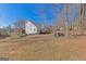 Expansive backyard with lush greenery, a wooden deck and natural surroundings at 245 Longshore Way, Fayetteville, GA 30215