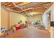 Spacious unfinished basement with exposed ceiling, a painted brick wall, and potential for customization at 245 Longshore Way, Fayetteville, GA 30215