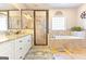 Elegant bathroom with a soaking tub, a shower, and a double vanity with granite countertops at 245 Longshore Way, Fayetteville, GA 30215