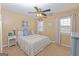 Cozy bedroom featuring a ceiling fan, carpeted floors, and plenty of natural light through two windows at 245 Longshore Way, Fayetteville, GA 30215