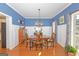 Traditional dining room with blue walls, white wainscoting, and a wooden dining set at 245 Longshore Way, Fayetteville, GA 30215