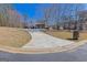 Long driveway winds to a lovely home with mature trees and landscaping enhancing its curb appeal at 245 Longshore Way, Fayetteville, GA 30215