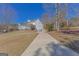 Charming home with a long driveway, attached garages, and a well-manicured front yard at 245 Longshore Way, Fayetteville, GA 30215