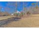 Spacious backyard with a long driveway, mature trees and natural surroundings at 245 Longshore Way, Fayetteville, GA 30215
