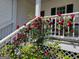 Charming front porch adorned with climbing roses, adding a touch of elegance to the home's entrance at 245 Longshore Way, Fayetteville, GA 30215