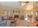 Bright living room featuring a fireplace, hardwood floors, and a vaulted ceiling at 245 Longshore Way, Fayetteville, GA 30215