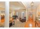 Inviting living room features hardwood floors, area rug, piano, and comfortable seating at 245 Longshore Way, Fayetteville, GA 30215