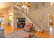 Open-concept living room with a fireplace and staircase to the second floor at 245 Longshore Way, Fayetteville, GA 30215