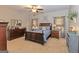 Comfortable main bedroom with carpet floors, a ceiling fan, and ample natural light at 245 Longshore Way, Fayetteville, GA 30215