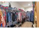 Spacious walk-in closet with ample storage and organization, showcasing clothing racks and shoe storage at 245 Longshore Way, Fayetteville, GA 30215