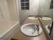 Bathroom featuring double sinks, a tub, and a large mirror at 7810 Capps Ferry Rd, Douglasville, GA 30135