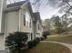 Light green house with neat landscaping and trees in the background at 7810 Capps Ferry Rd, Douglasville, GA 30135