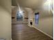 Living room featuring light walls, fireplace, and light-colored vinyl floors at 7810 Capps Ferry Rd, Douglasville, GA 30135