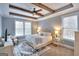 Serene bedroom with tray ceilings, ceiling fan, and an abundance of natural light at 1080 Gaithers Rd, Mansfield, GA 30055