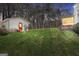 Expansive backyard with lush green lawn, outbuilding, and screened sunroom offers room for outdoor enjoyment at 415 Southmoor Cir, Stockbridge, GA 30281