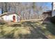 Large backyard with green grass and a storage shed on the property at 415 Southmoor Cir, Stockbridge, GA 30281