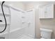 Bright bathroom featuring a white shower with built in shelves and a wall mounted vanity at 415 Southmoor Cir, Stockbridge, GA 30281