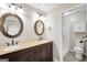 A spacious bathroom featuring dual sinks, ornate mirrors, and a shower behind an open doorway at 415 Southmoor Cir, Stockbridge, GA 30281