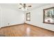 A spacious bedroom features wood floors, two windows letting in natural light, and a ceiling fan at 415 Southmoor Cir, Stockbridge, GA 30281