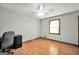 Neutral bedroom with hardwood floors, desk, and window with bright natural light at 415 Southmoor Cir, Stockbridge, GA 30281