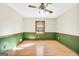 This bedroom has a ceiling fan, wood floors, and a neutral paint scheme that makes it feel cozy at 415 Southmoor Cir, Stockbridge, GA 30281