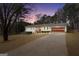 Charming single-story home with a well-maintained lawn and cozy curb appeal at twilight at 415 Southmoor Cir, Stockbridge, GA 30281