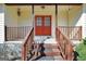 Close-up of the front entry with a red double-door and wooden steps at 415 Southmoor Cir, Stockbridge, GA 30281