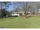 Charming single-story home boasts a well-manicured lawn and inviting curb appeal at 415 Southmoor Cir, Stockbridge, GA 30281